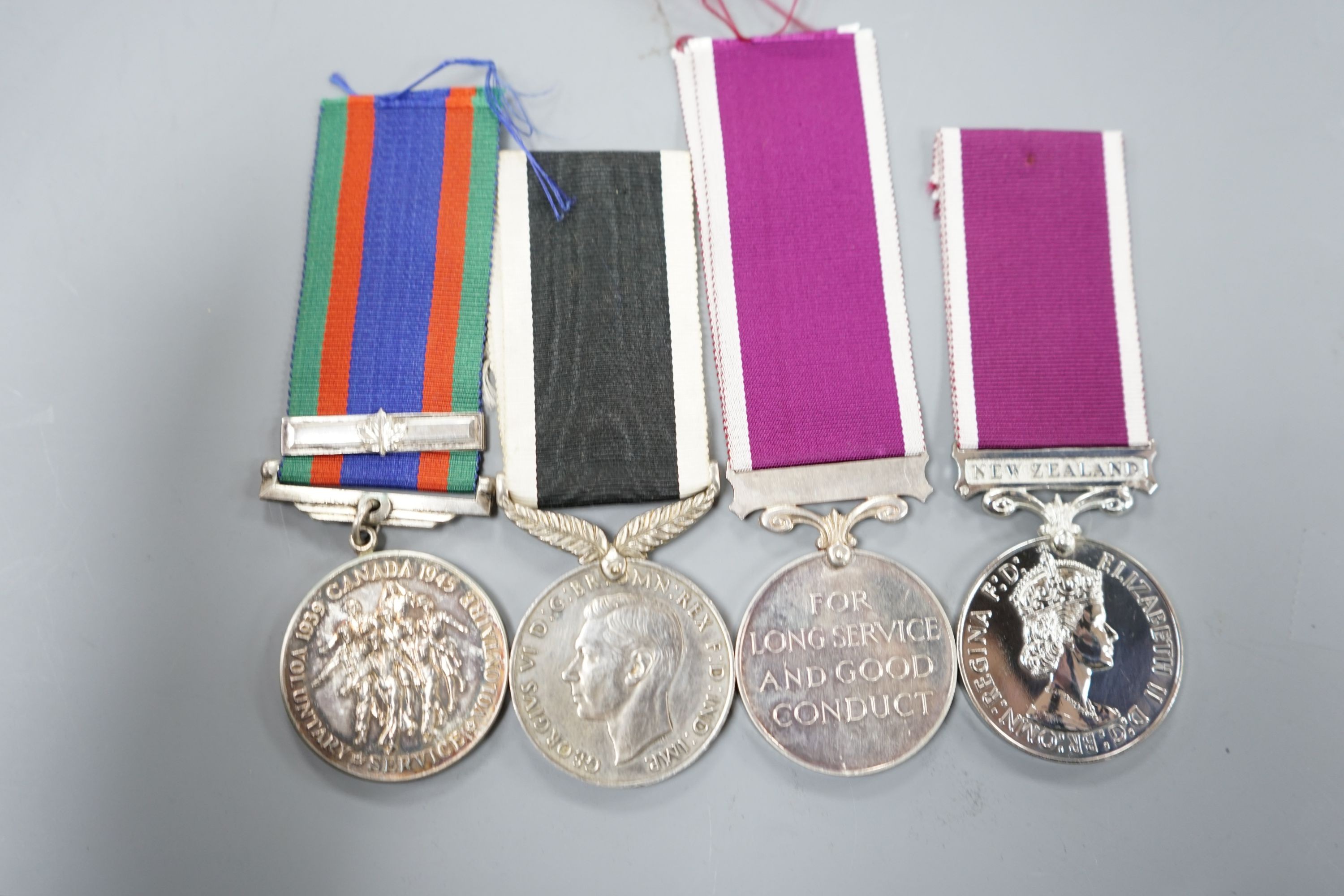 Four WW2 and QEII Commonwealth medals - New Zealand War Service and For Long Service and Good Conduct medals, Canada Voluntary Service medal and a Regular Army For Long Service and Good Conduct medal